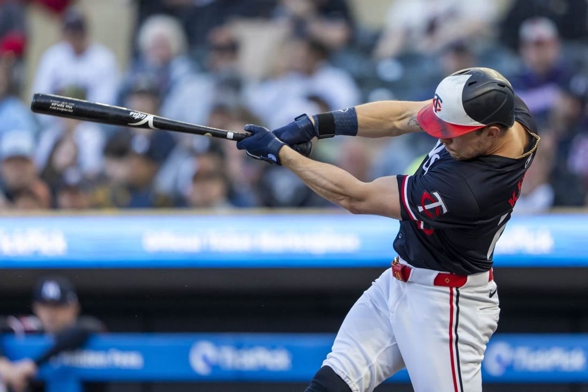 Apr 22, 2024; Minneapolis, Minnesota, USA; Minnesota Twins right fielder Max Kepler (26) hits a RBI double against the Chicago White Sox in the first inning at Target Field.