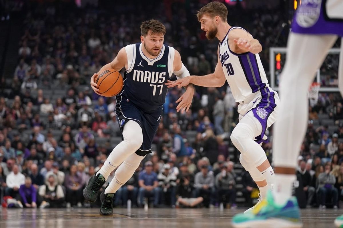 Mar 29, 2024; Sacramento, California, USA; Dallas Mavericks guard Luka Doncic (77) dribbles next to Sacramento Kings forward Domantas Sabonis (10) in the first quarter at the Golden 1 Center.