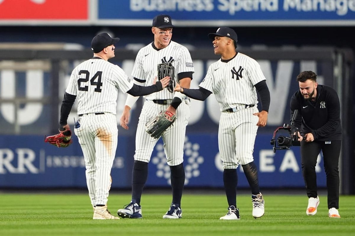 Apr 8, 2024; Bronx, New York, USA; New York Yankees left fielder Alex Verdugo (24) right fielder Juan Soto (22), and center fielder Aaron Judge (99) celebrate the victory after the game against the Miami Marlins at Yankee Stadium.