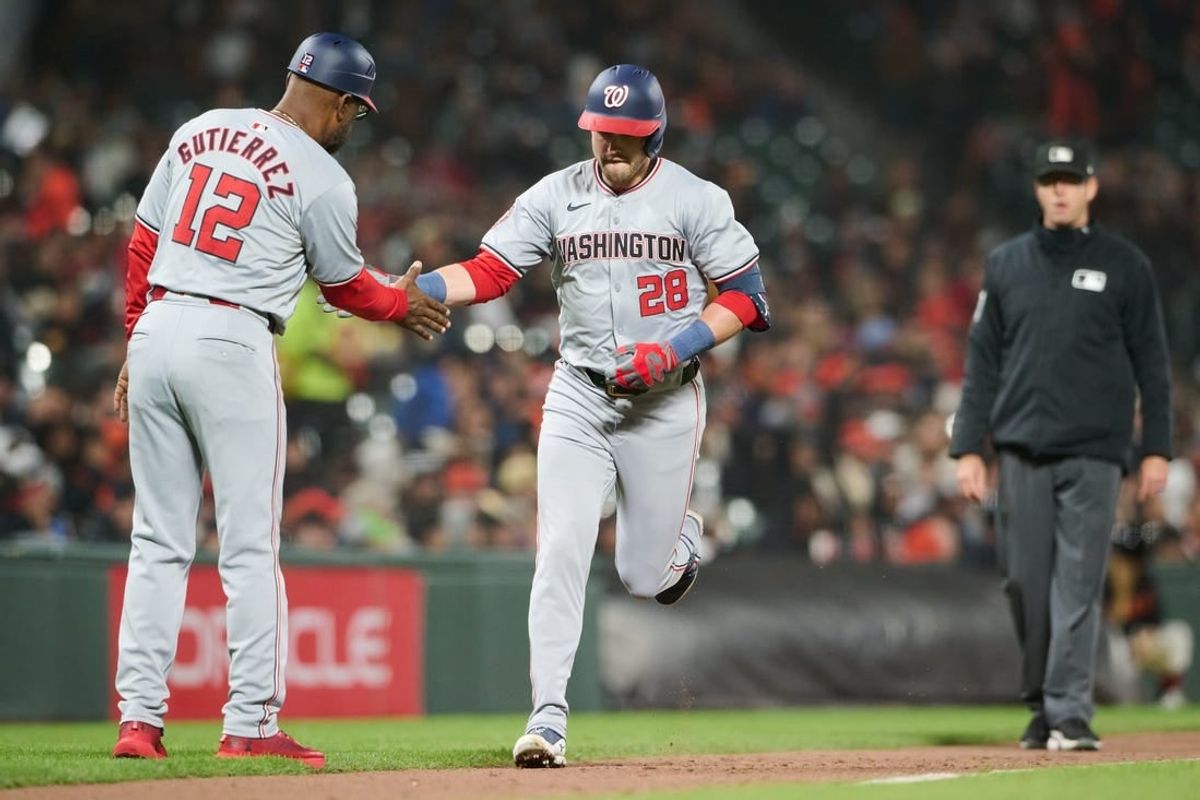 Apr 8, 2024; San Francisco, California, USA; Washington Nationals outfielder Lane Thomas (28) shakes hands with third base coach Ricky Gutierrez (12) after hitting a home run against the San Francisco Giants during the fifth inning at Oracle Park.