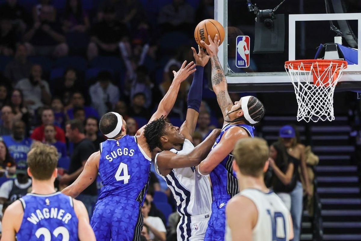 Mar 30, 2024; Orlando, Florida, USA; Orlando Magic forward Paolo Banchero (5) and guard Jalen Suggs (4) block a shot attempt by Memphis Grizzlies forward GG Jackson (45) during the first quarter at KIA Center.