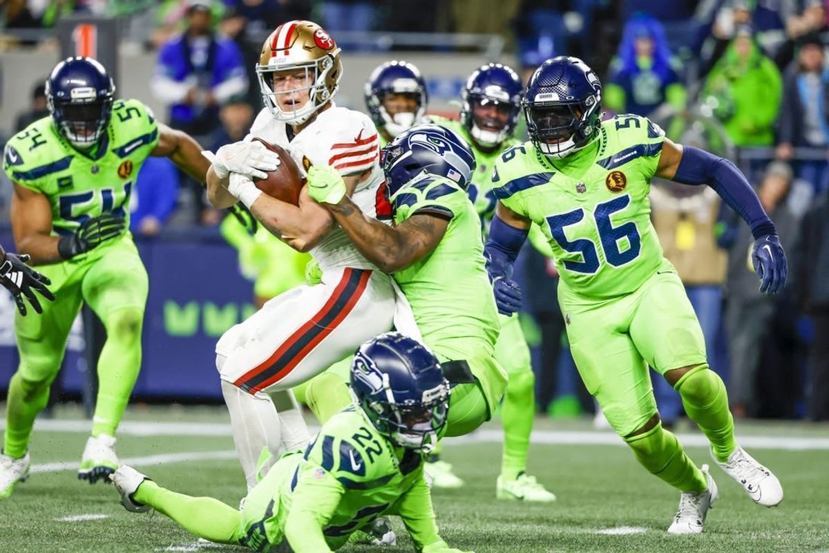 Nov 23, 2023; Seattle, Washington, USA; San Francisco 49ers running back Christian McCaffrey (23) rushes for a touchdown against Seattle Seahawks safety Quandre Diggs (6) and linebacker Jordyn Brooks (56) during the second quarter at Lumen Field.