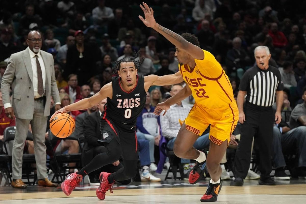 Dec 2, 2023; Las Vegas, Nevada, USA; Gonzaga Bulldogs guard Ryan Nembhard (0) dribbles against Southern California Trojans forward Arrinten Page (22) during the Legends of Basketball Las Vegas Invitational at MGM Grand Garden Arena.