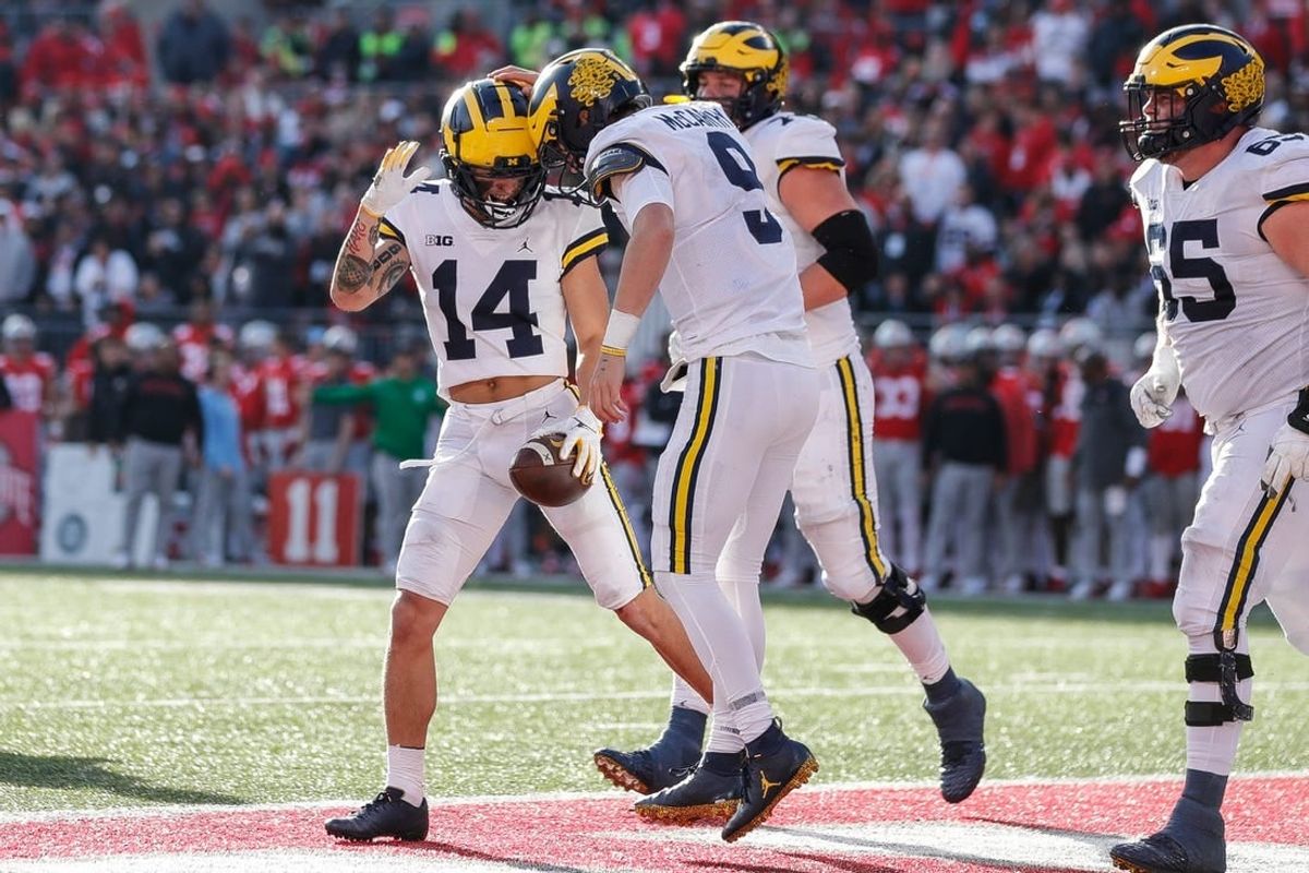 Projected top-50 picks Michigan quarterback J.J. McCarthy (9) and wide receiver Roman Wilson (14), pictured celebrating during a touchdown against Ohio State the second half at Ohio Stadium in 2022.