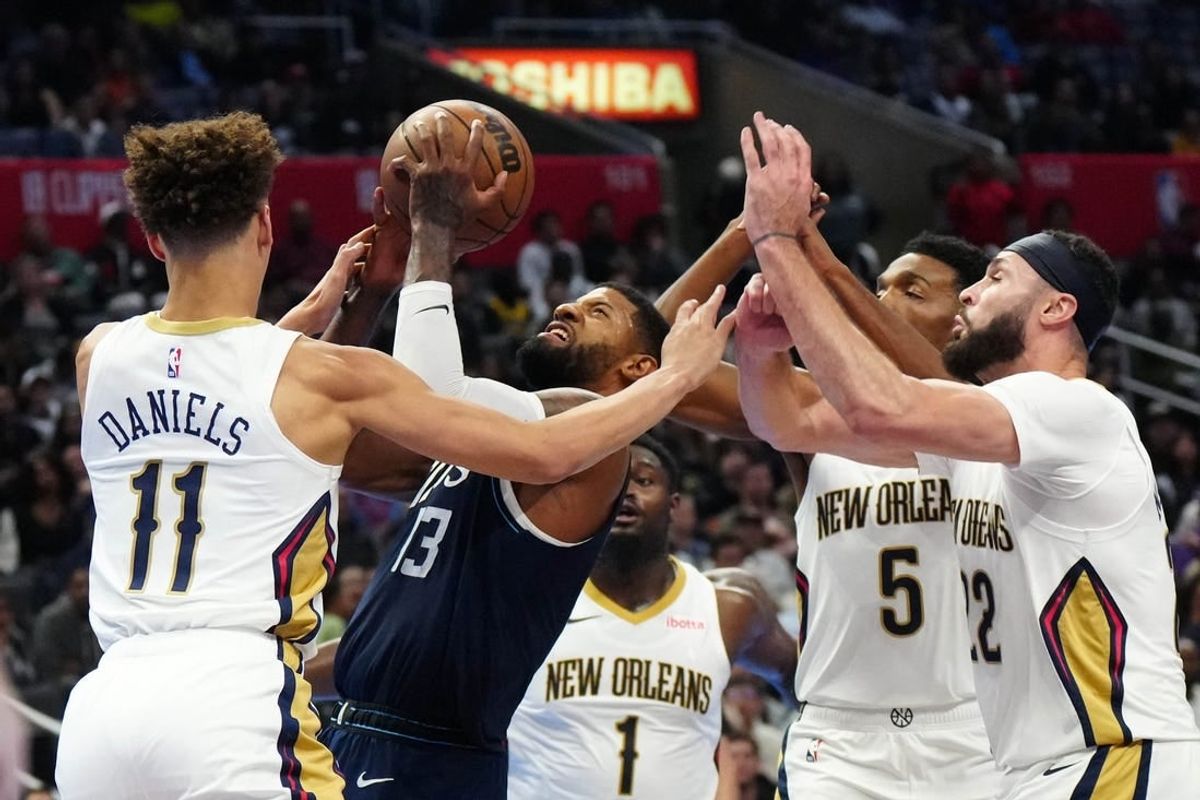 Nov 24, 2023; Los Angeles, California, USA; LA Clippers forward Paul George (13) shoots the ball against New Orleans Pelicans guard Dyson Daniels (11) and forwards Zion Williamson (1), Herbert Jones (5) and Larry Nance Jr. (22) in the second half at Crypto.com Arena.