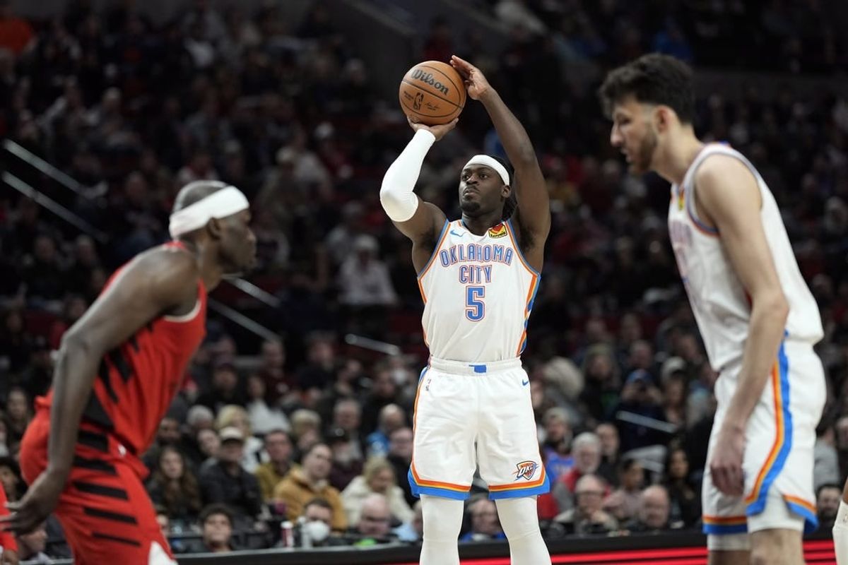 Mar 6, 2024; Portland, Oregon, USA; Oklahoma City Thunder guard Luguentz Dort (5) shoots the ball during the second half against the Portland Trail Blazers at Moda Center.