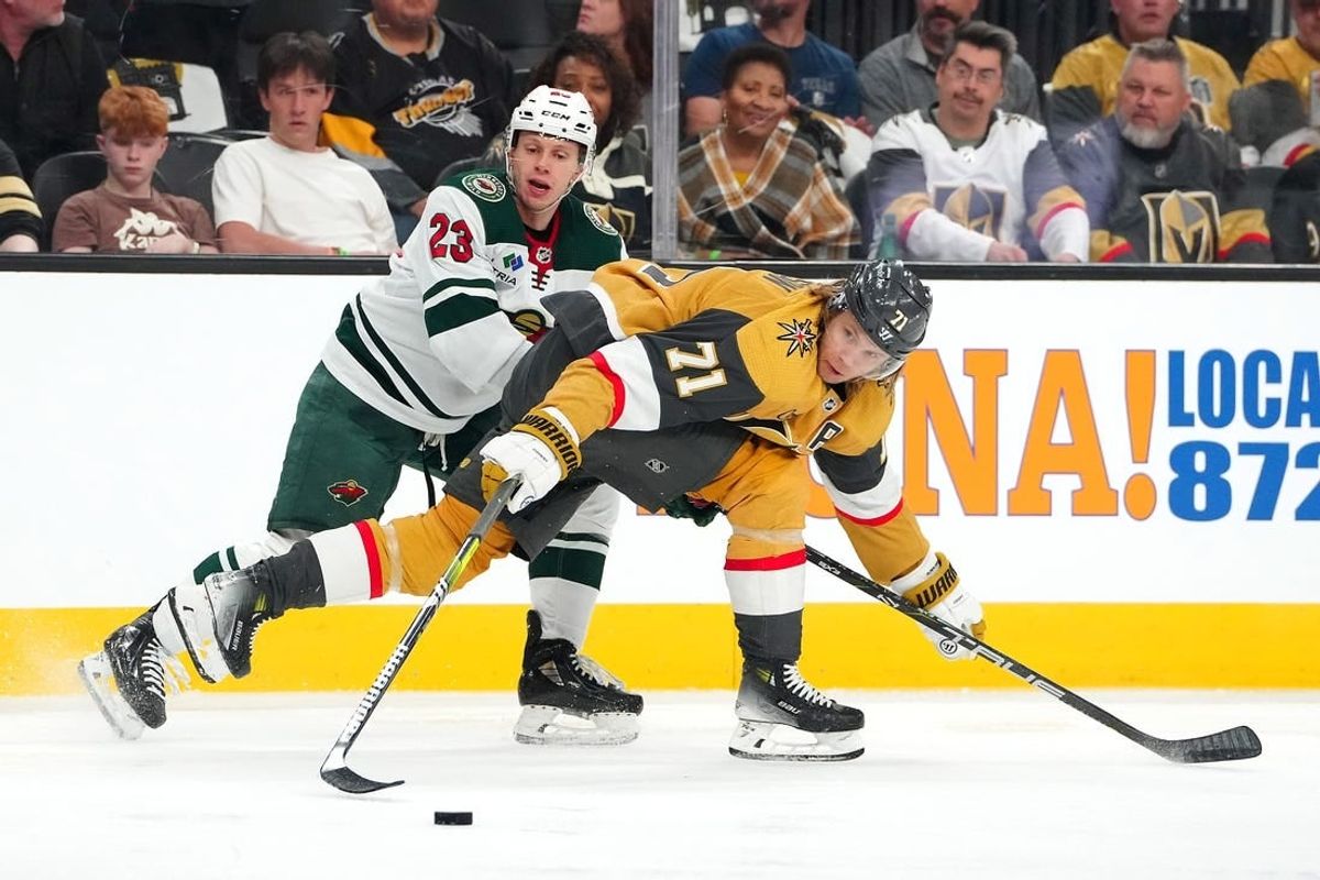 Apr 12, 2024; Las Vegas, Nevada, USA; Vegas Golden Knights center William Karlsson (71) skates the puck away from Minnesota Wild center Marco Rossi (23) during the first period at T-Mobile Arena.