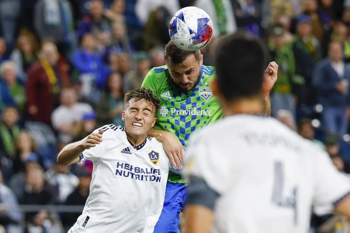Oct 4, 2023; Seattle, Washington, USA; Seattle Sounders FC forward Jordan Morris (13, right) heads a cross against Los Angeles Galaxy defender Julian Aude (3) during the first half at Lumen Field.