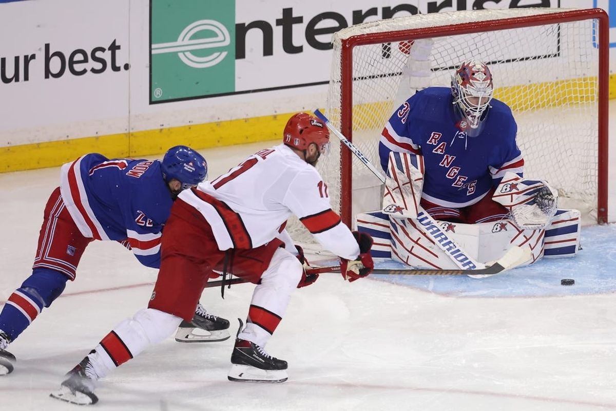 May 7, 2024; New York, New York, USA; New York Rangers goaltender Igor Shesterkin (31) makes a save against Carolina Hurricanes center Jordan Staal (11) in front of Rangers center Barclay Goodrow (21) during the second overtime of game two of the second round of the 2024 Stanley Cup Playoffs at Madison Square Garden.
