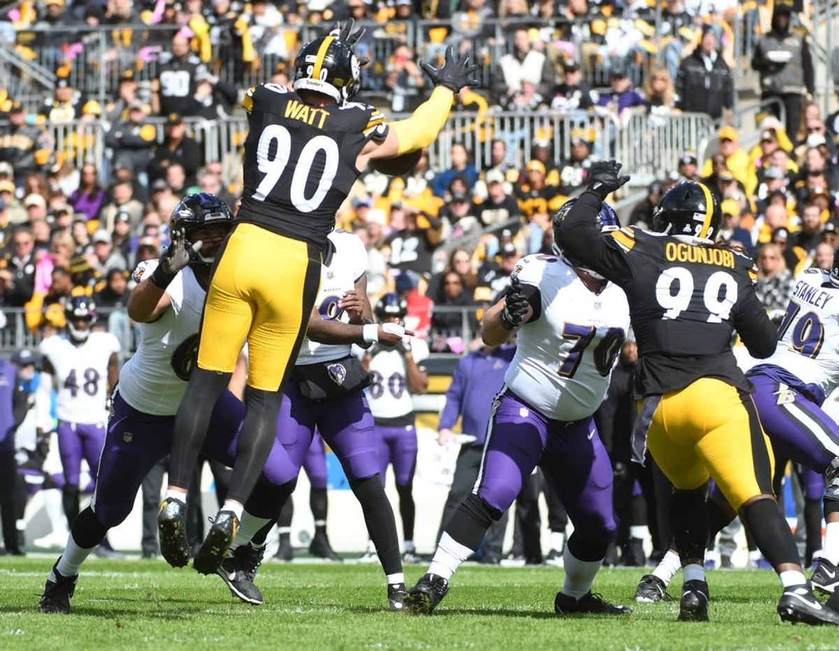 Oct 8, 2023; Pittsburgh, Pennsylvania, USA;  Baltimore Ravens  quarterback Lamar Jackson (8)  has a pass blocked by Pittsburgh Steelers linebacker T.J. Watt (90) during the first quarter at Acrisure Stadium.