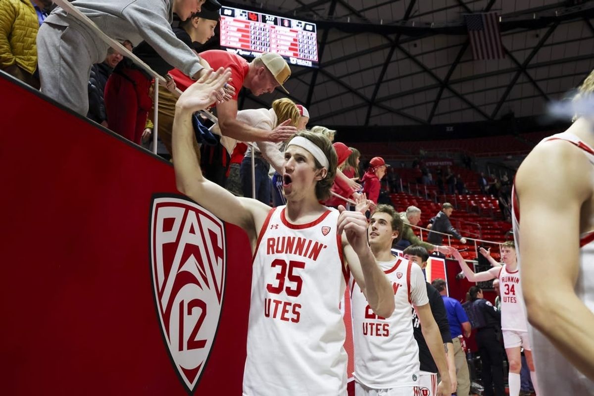Feb 29, 2024; Salt Lake City, Utah, USA; Utah Utes center Branden Carlson (35) slaps hands with fans after the win against the Stanford Cardinal at Jon M. Huntsman Center.