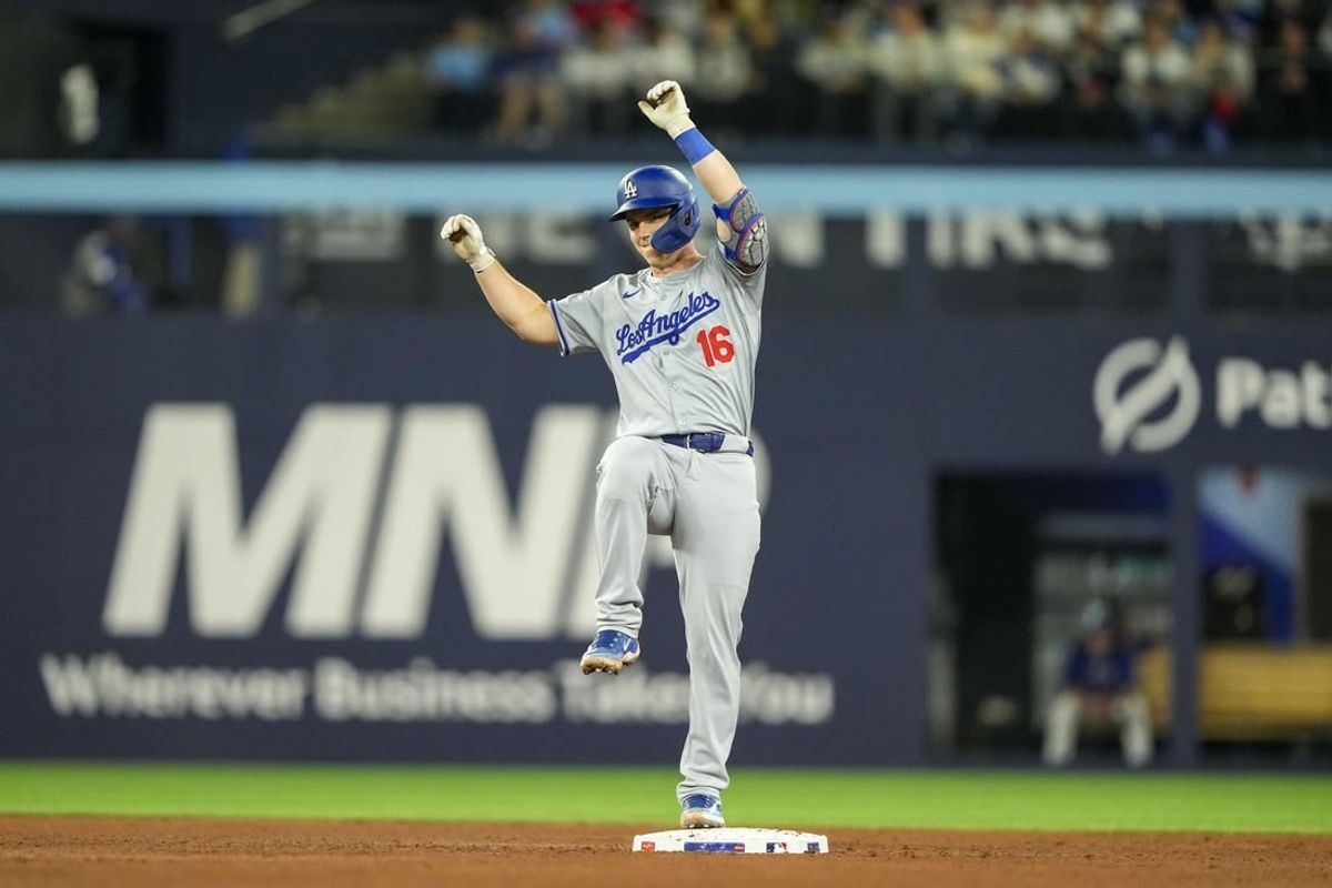 Apr 26, 2024; Toronto, Ontario, CAN; Los Angeles Dodgers catcher Will Smith (16) celebrates as he steps on second base against the Toronto Blue Jays during the sixth inning at Rogers Centre.