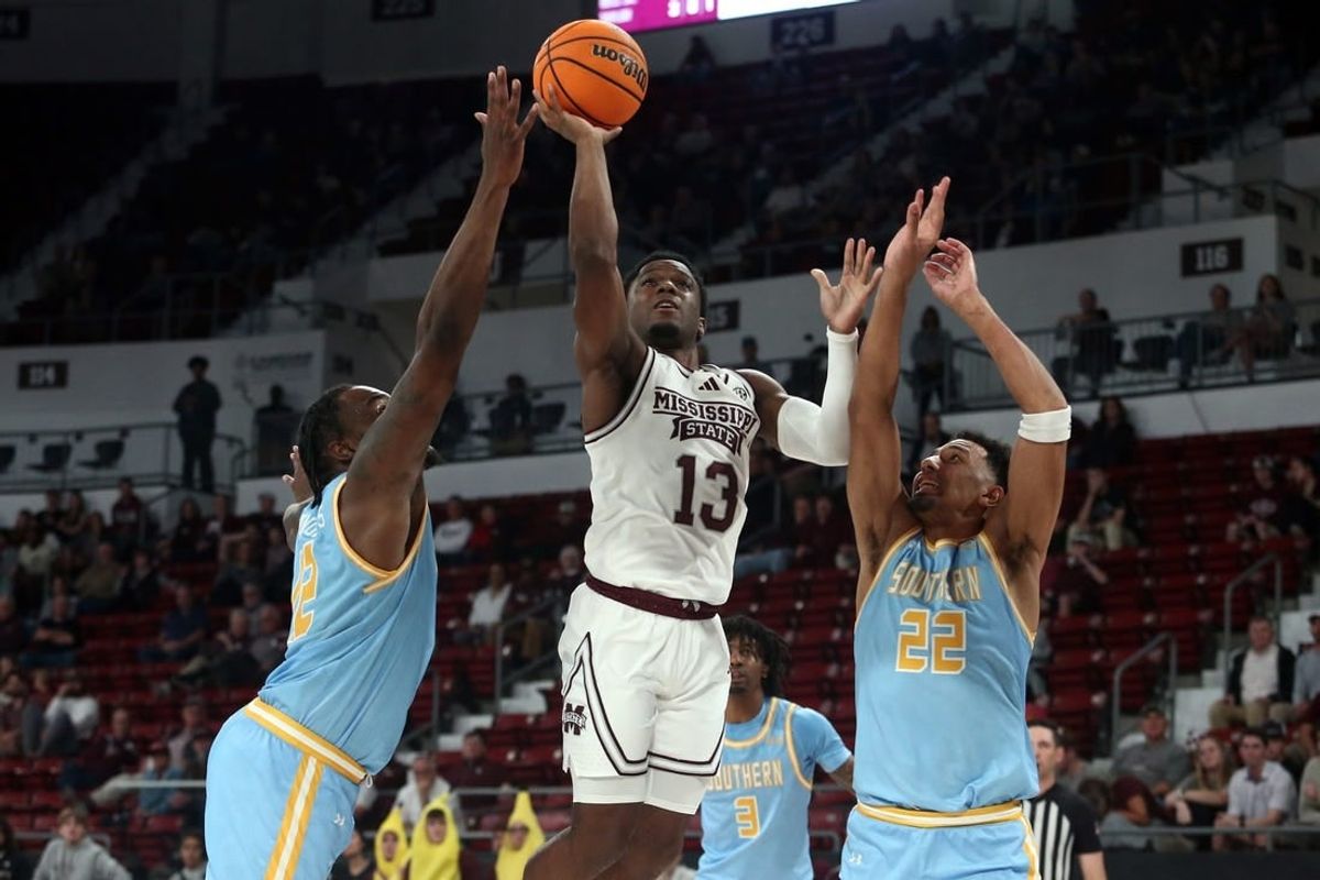 Dec 3, 2023; Starkville, Mississippi, USA; Mississippi State Bulldogs guard Josh Hubbard (13) shoots against Southern Jaguars forward Jalen Reynolds (12) and Southern Jaguars guard Tidjiane Dioumassi (22) during the first half at Humphrey Coliseum.