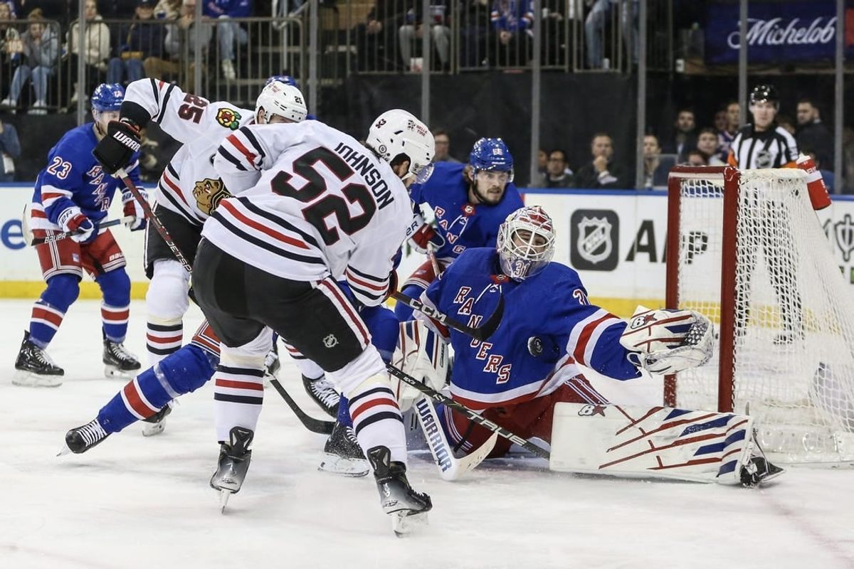 Jan 4, 2024; New York, New York, USA; New York Rangers goaltender Igor Shesterkin (31) makes a save on a shot on goal attempt by Chicago Blackhawks center Reese Johnson (52) at Madison Square Garden.