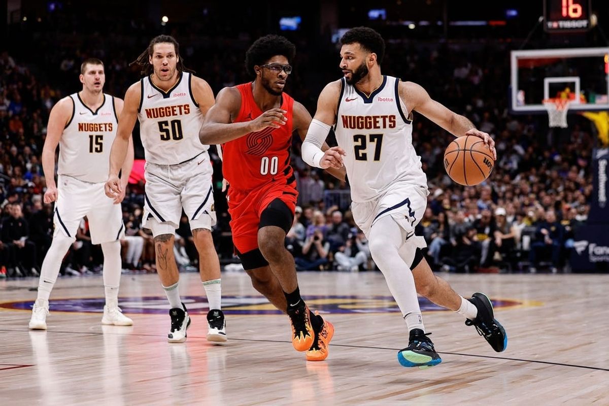 Feb 4, 2024; Denver, Colorado, USA; Denver Nuggets guard Jamal Murray (27) controls the ball against Portland Trail Blazers guard Scoot Henderson (00) as forward Aaron Gordon (50) and center Nikola Jokic (15) defend in the second quarter at Ball Arena.