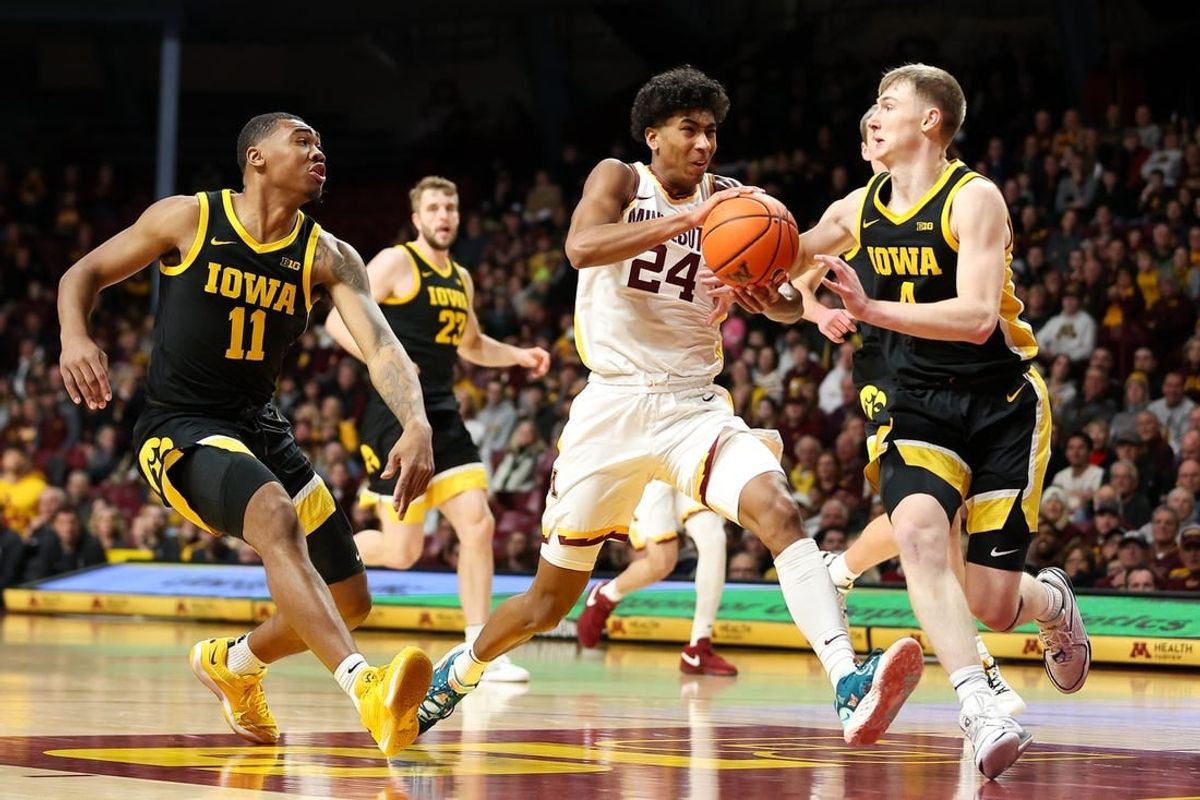 Jan 15, 2024; Minneapolis, Minnesota, USA; Minnesota Golden Gophers guard Cam Christie (24) works up court as Iowa Hawkeyes guard Josh Dix (4) and guard Tony Perkins (11) defend during the first half at Williams Arena.