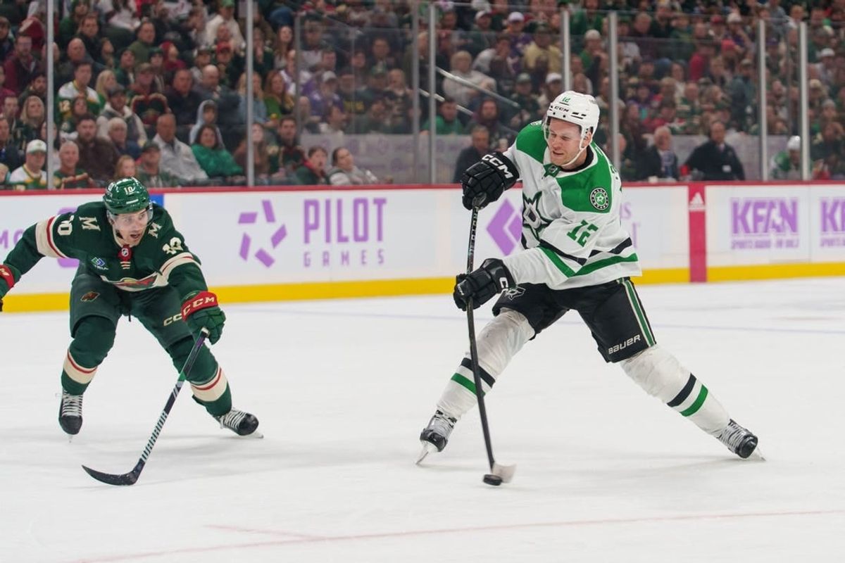 Nov 12, 2023; Saint Paul, Minnesota, USA; Dallas Stars center Radek Faksa (12) shoots and scores Minnesota Wild center Vinni Lettieri (10) on defense in the first period at Xcel Energy Center.