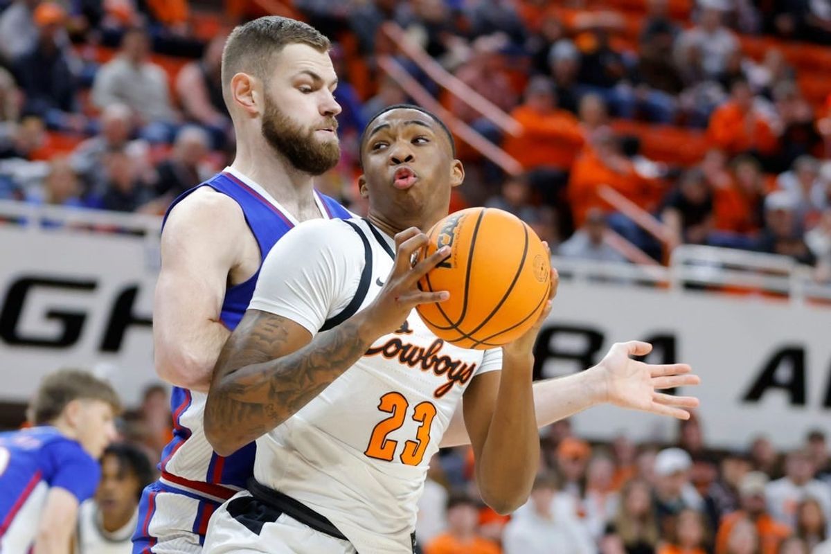 Oklahoma State Cowboys center Brandon Garrison (23) tries to get past Kansas Jayhawks center Hunter Dickinson (1) during a college basketball game between the Oklahoma State University Cowboys (OSU) and the Kansas Jayhawks at Gallagher-Iba Arena in Stillwater, Okla., Tuesday, Jan. 16, 2024.
