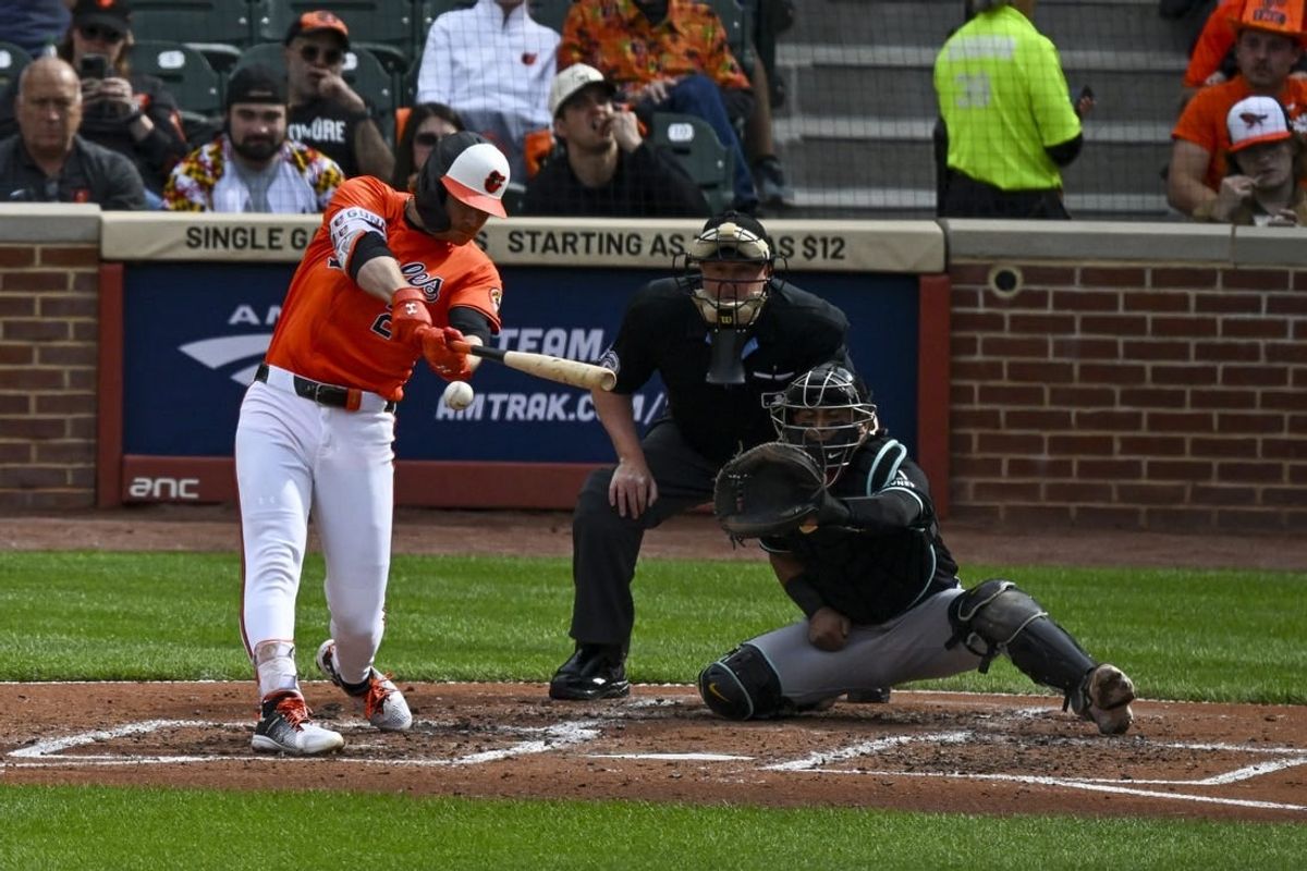 May 11, 2024; Baltimore, Maryland, USA; Baltimore Orioles shortstop Gunnar Henderson (2) drives a ball to right field for a third inning single against the Arizona Diamondbacks  at Oriole Park at Camden Yards.