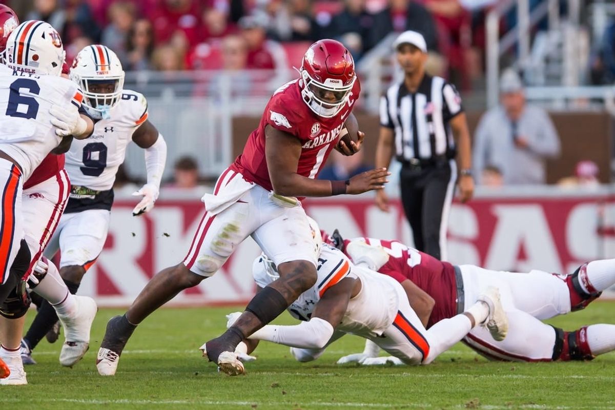 Nov 11, 2023; Fayetteville, Arkansas, USA;  Arkansas Razorbacks quarterback KJ Jefferson (1) gets past Auburn Tigers linebacker Elijah McAllister (11) during the second quarter at Donald W. Reynolds Razorback Stadium.