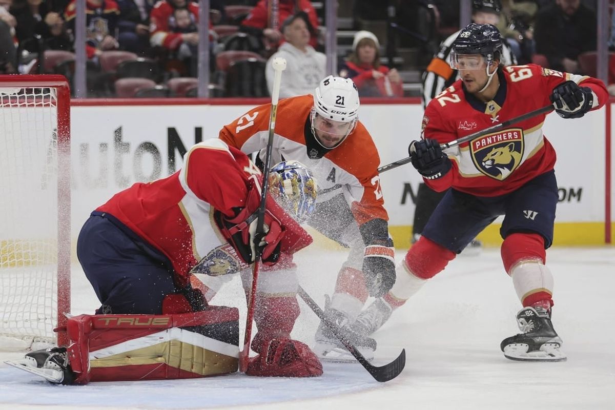 Feb 6, 2024; Sunrise, Florida, USA; Florida Panthers goaltender Anthony Stolarz (41) controls the puck after a shot by Philadelphia Flyers center Scott Laughton (21) during the first period at Amerant Bank Arena.
