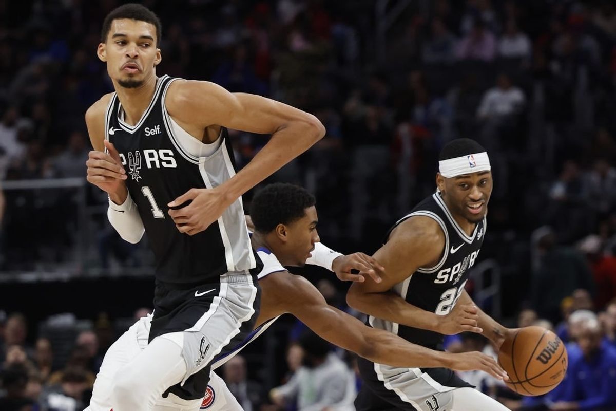 Jan 10, 2024; Detroit, Michigan, USA;  San Antonio Spurs guard Malaki Branham (22) dribbles off the pick by center Victor Wembanyama (1) defended by Detroit Pistons guard Jaden Ivey (23) in the second half at Little Caesars Arena.