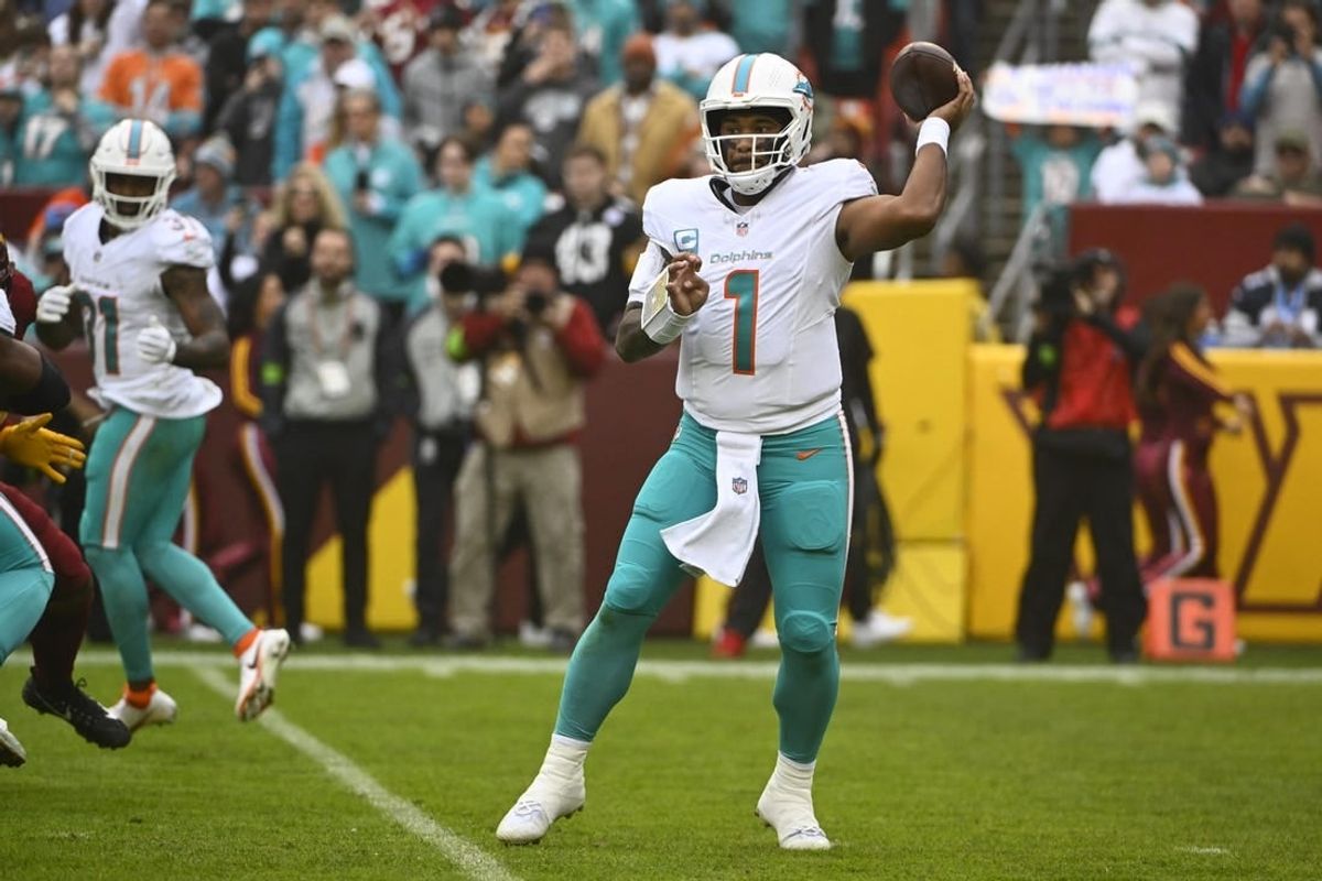 Dec 3, 2023; Landover, Maryland, USA; Miami Dolphins quarterback Tua Tagovailoa (1) drops back to pass against the Washington Commanders during the first half at FedExField.