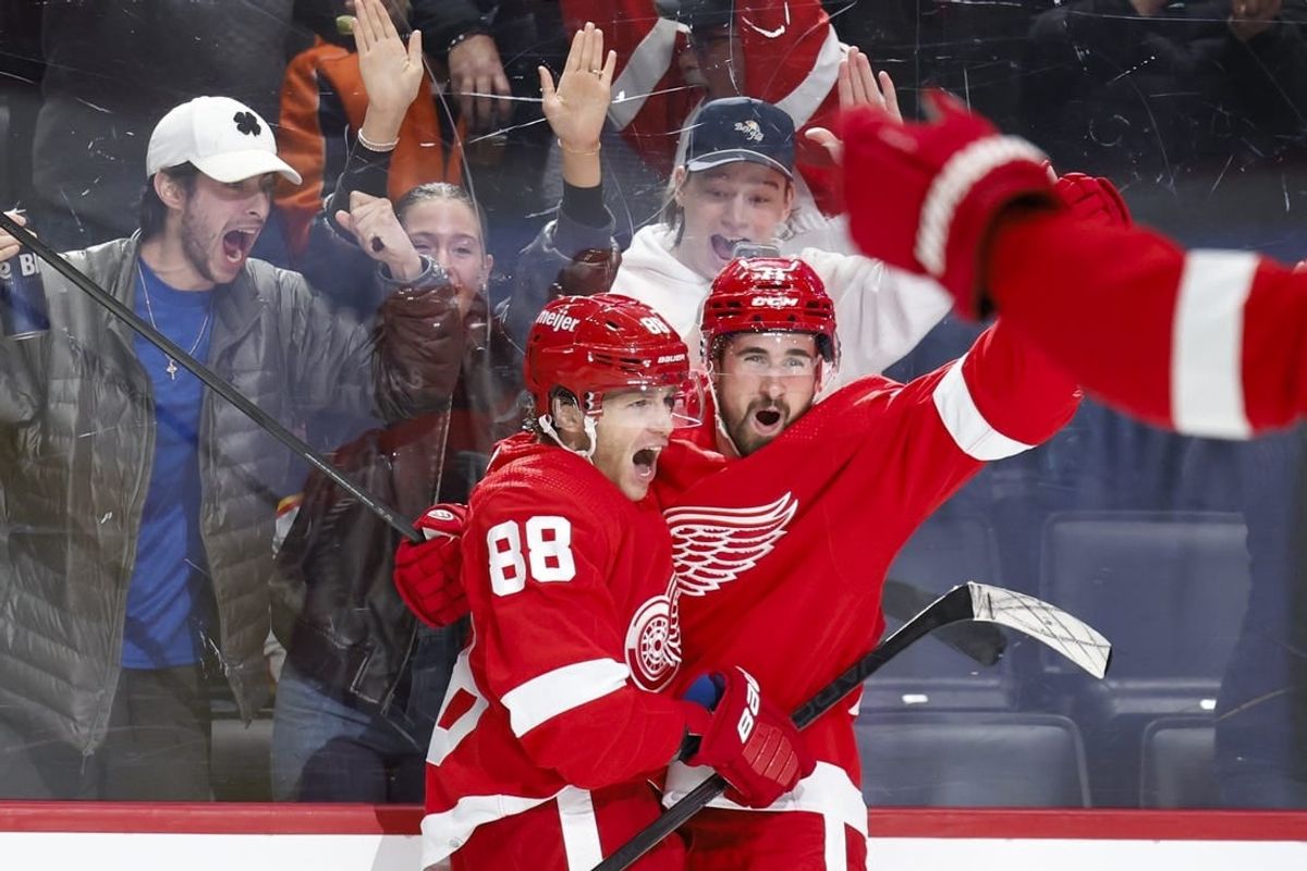 Feb 22, 2024; Detroit, Michigan, USA;  Detroit Red Wings right wing Patrick Kane (88) receives congratulations from center Dylan Larkin (71) after scoring in overtime against the Colorado Avalanche at Little Caesars Arena.