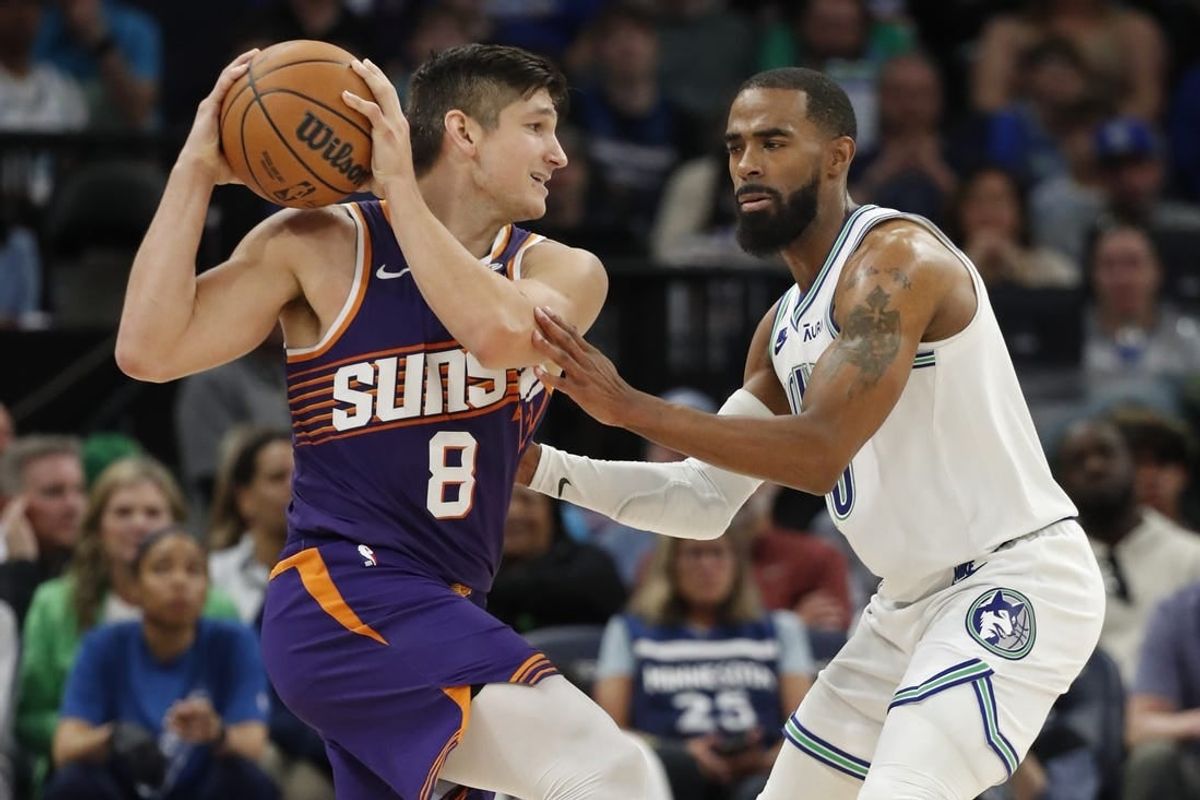 Apr 14, 2024; Minneapolis, Minnesota, USA; Phoenix Suns guard Grayson Allen (8) works around Minnesota Timberwolves guard Mike Conley (10) in the fourth quarter at Target Center.