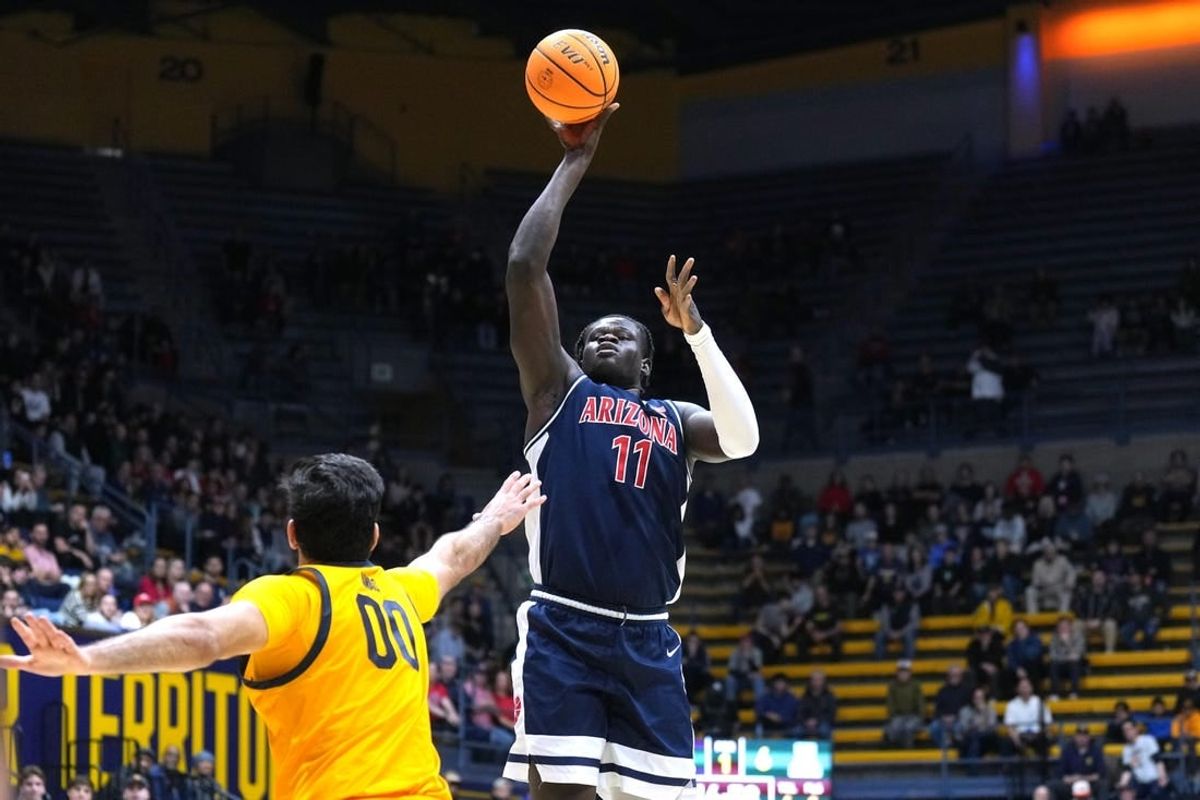 Dec 29, 2023; Berkeley, California, USA; Arizona Wildcats center Oumar Ballo (11) shoots against California Golden Bears forward Fardaws Aimaq (00) during the first half at Haas Pavilion.