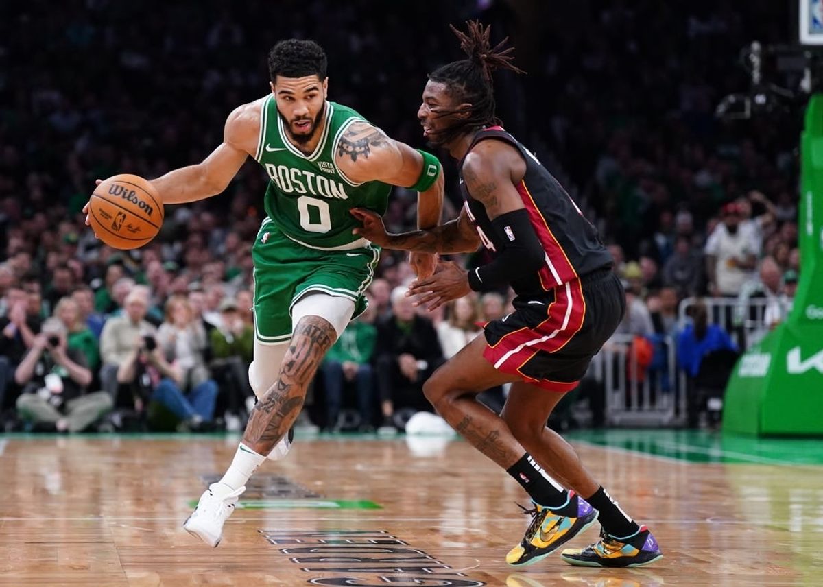 Apr 24, 2024; Boston, Massachusetts, USA; Boston Celtics forward Jayson Tatum (0) drives the ball against Miami Heat guard Delon Wright (4) in the second quarter during game two of the first round for the 2024 NBA playoffs at TD Garden.
