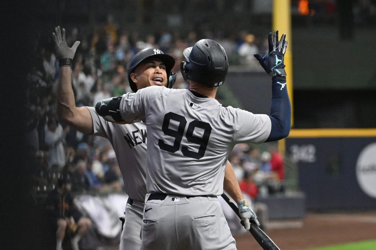 Apr 28, 2024; Milwaukee, Wisconsin, USA; New York Yankees designated hitter Giancarlo Stanton (27) congratulates New York Yankees outfielder Aaron Judge (99) after hitting home run against Milwaukee Brewers in the first inning at American Family Field.