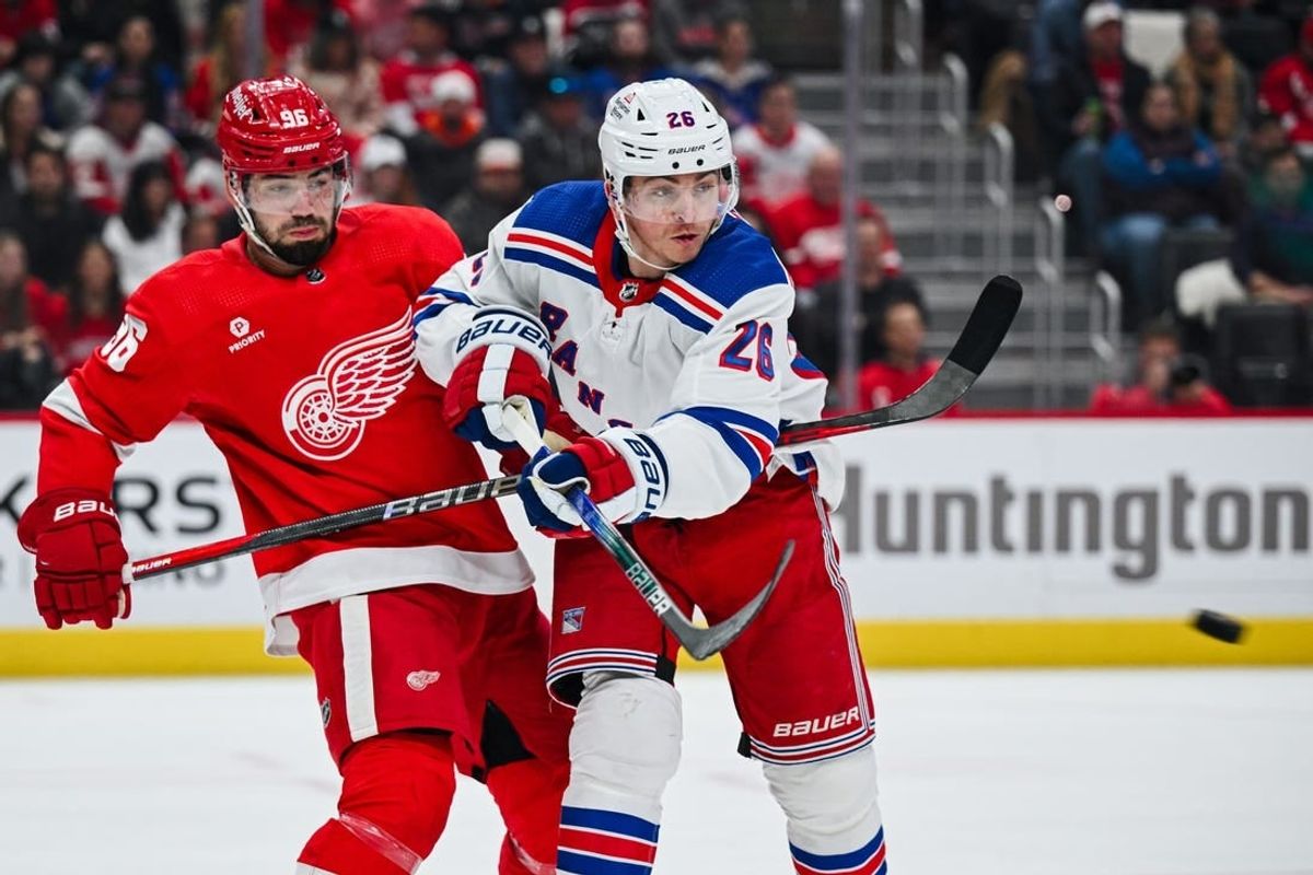 Apr 5, 2024; Detroit, Michigan, USA; New York Rangers left wing Jimmy Vesey (26) and Detroit Red Wings defenseman Jake Walman (96) battle for the puck during the first period at Little Caesars Arena.