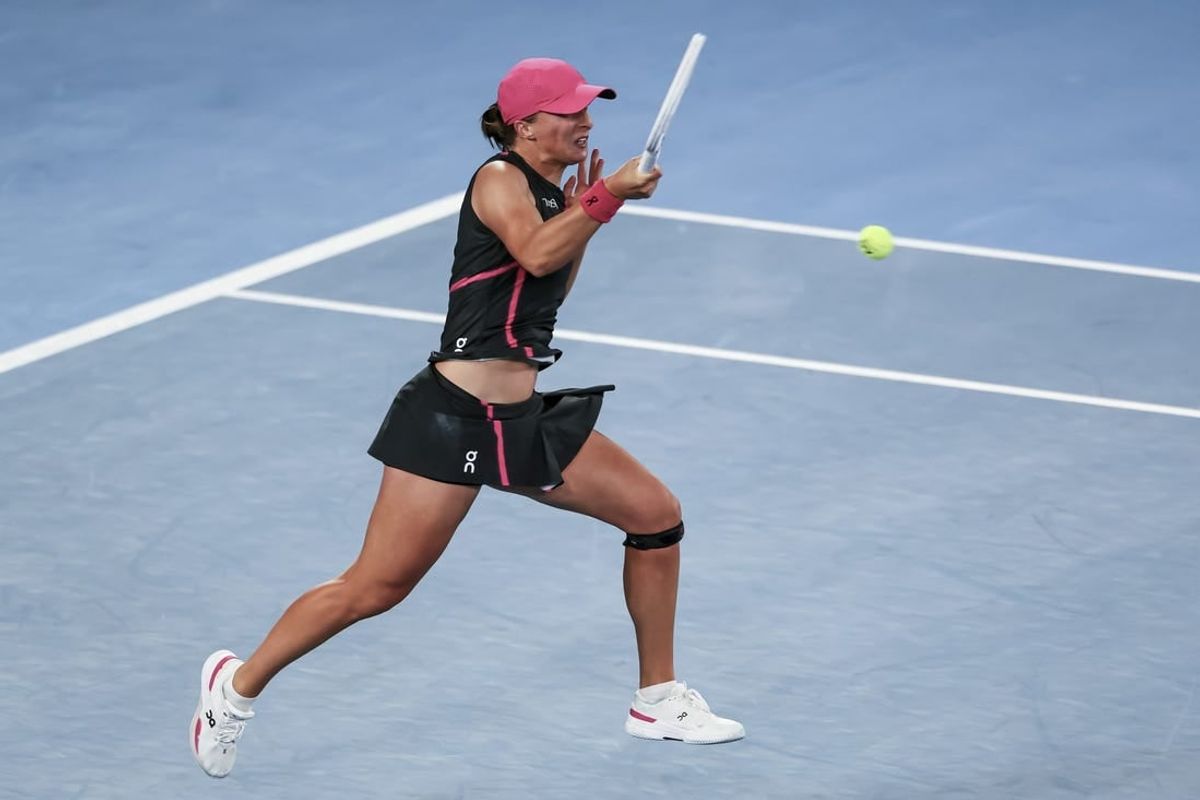 Jan 20, 2024; Melbourne, Victoria, Australia; Iga Swiatek of Poland plays a shot against Linda Noskova (not pictured) of Czechia in Round 3 of the Women's Singles on Day 7 of the Australian Open tennis at Rod Laver Arena.