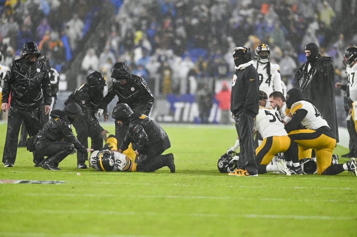 Jan 6, 2024; Baltimore, Maryland, USA;  Pittsburgh Steelers medical staff tend to inebacker T.J. Watt (left) as teammates take a knee during the third  quarter against the Baltimore Ravens at M&T Bank Stadium.