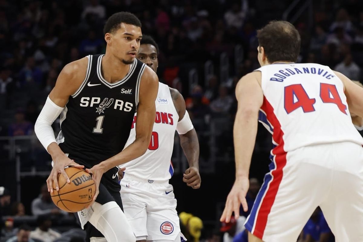 Jan 10, 2024; Detroit, Michigan, USA;  San Antonio Spurs center Victor Wembanyama (1) dribbles defended by Detroit Pistons forward Bojan Bogdanovic (44) in the first half at Little Caesars Arena.