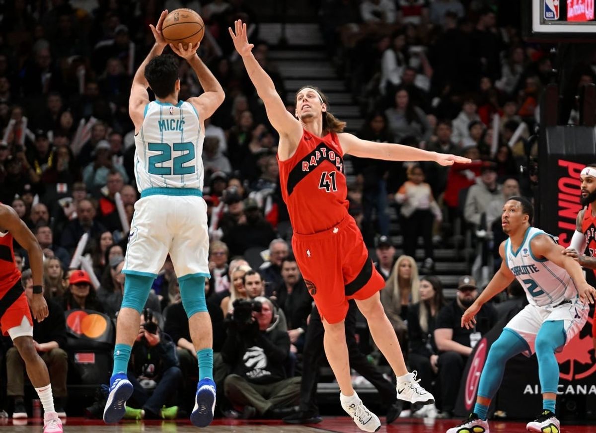 Mar 3, 2024; Toronto, Ontario, CAN;  Charlotte Hornets guard Vasa Micic (22) shoots the ball as Toronto Raptors center Kelly Olynyk (41) defends in the first half at Scotiabank Arena.