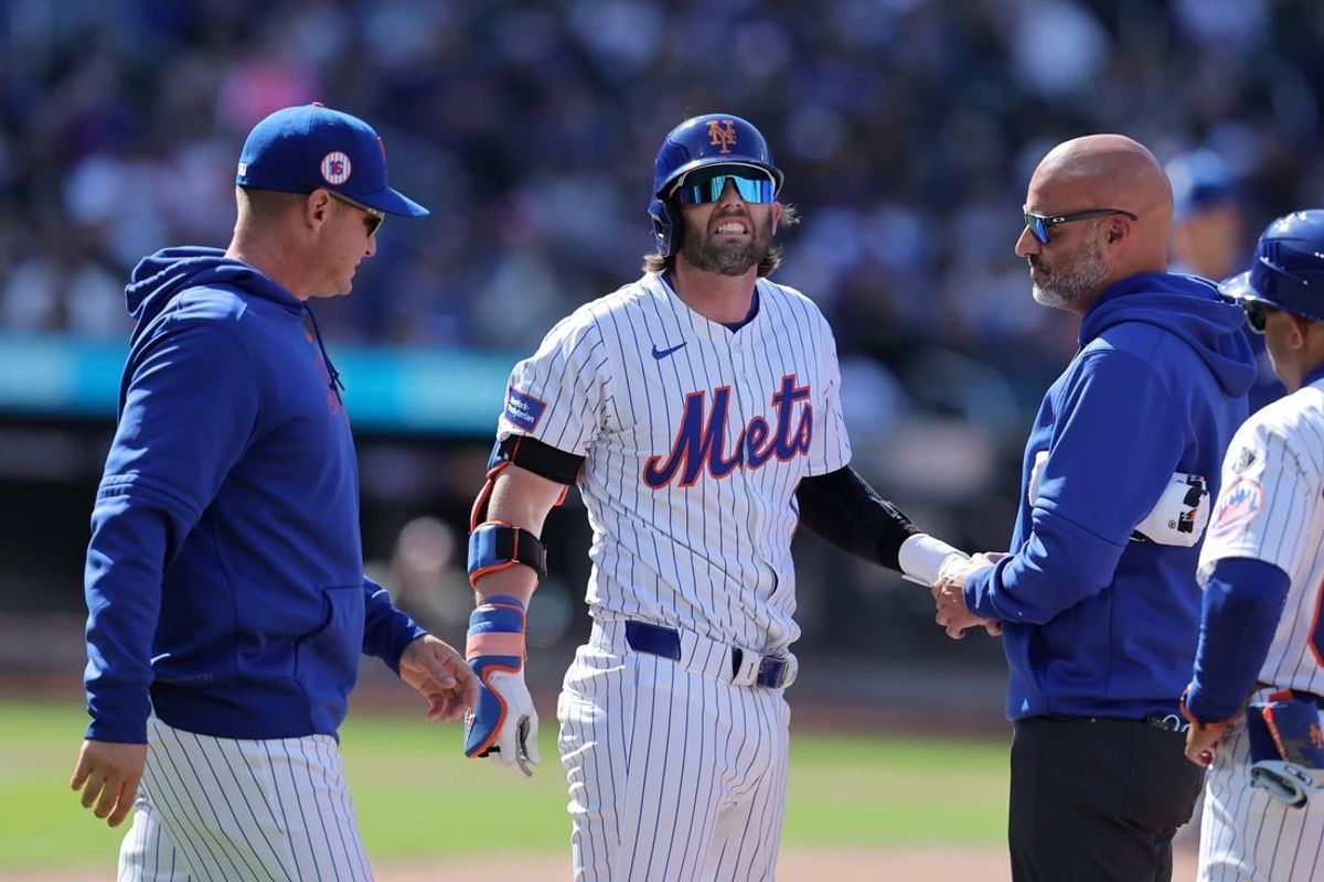 Apr 14, 2024; New York City, New York, USA; New York Mets second baseman Jeff McNeil (1) is checked out after being hit in the hand by a pitch during the fifth inning against the Kansas City Royals at Citi Field.