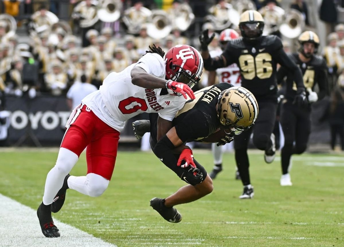 Nov 25, 2023; West Lafayette, Indiana, USA; Purdue Boilermakers defensive back Cam Allen (10) intercepts a pass intended for Indiana Hoosiers wide receiver Andison Coby (0) during the first half at Ross-Ade Stadium.