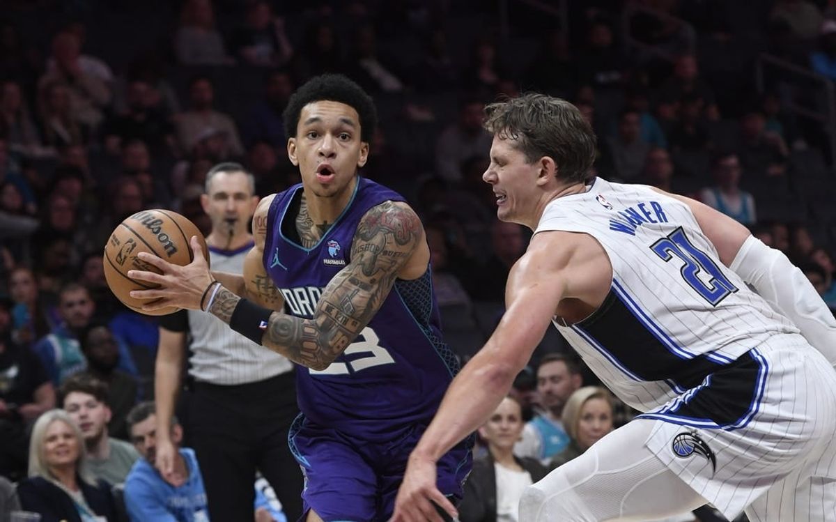 Mar 5, 2024; Charlotte, North Carolina, USA;  Charlotte Hornets guard Tre Mann (23) drives past Orlando Magic center Moritz Wagner (21) during the second half at the Spectrum Center.
