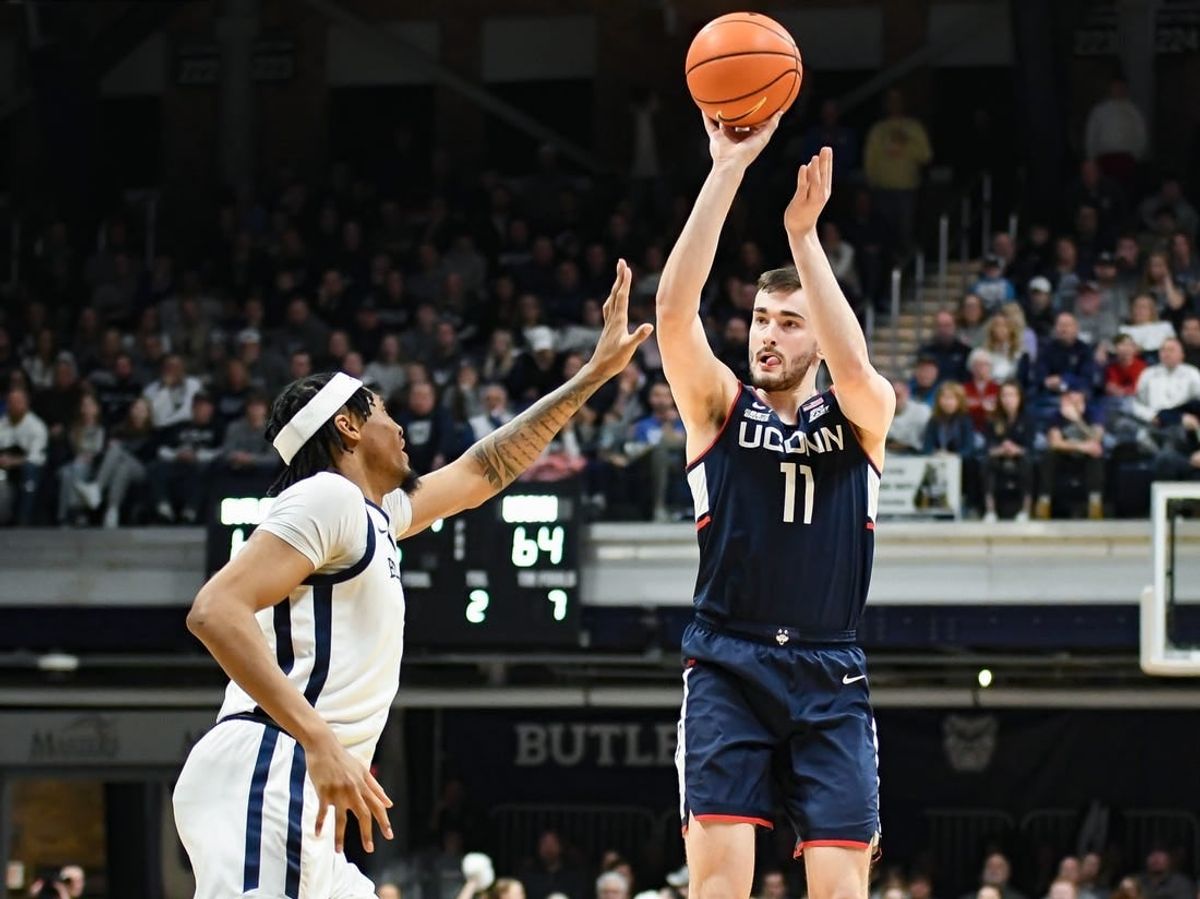 Jan 5, 2024; Indianapolis, Indiana, USA; Connecticut Huskies forward Alex Karaban (11) attempts a shot over Butler Bulldogs forward Jalen Thomas (1) during the second half at Hinkle Fieldhouse.