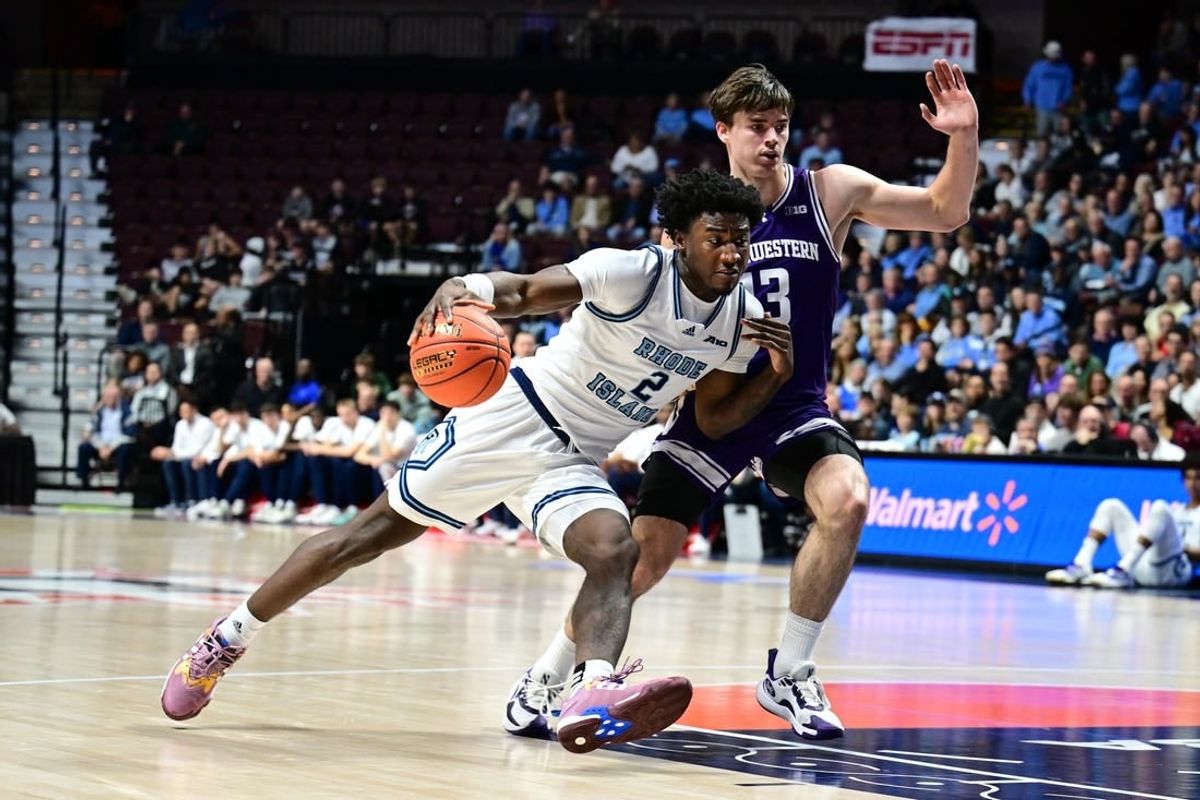 Nov 18, 2023; Uncasville, Connecticut, USA; Rhode Island Rams guard Jaden House (2) dribbles the ball around Northwestern Wildcats guard Brooks Barnhizer (13) during the first half at Mohegan Sun Arena.
