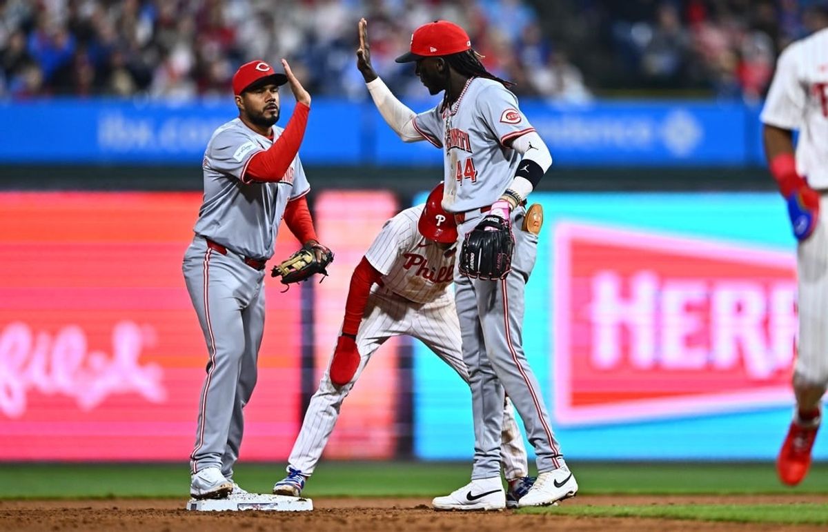Apr 1, 2024; Philadelphia, Pennsylvania, USA; Cincinnati Reds third baseman Jeimer Candelario (3) and shortstop Elly De La Cruz (44) celebrate after a tag-out against the Philadelphia Phillies in the eighth inning at Citizens Bank Park.