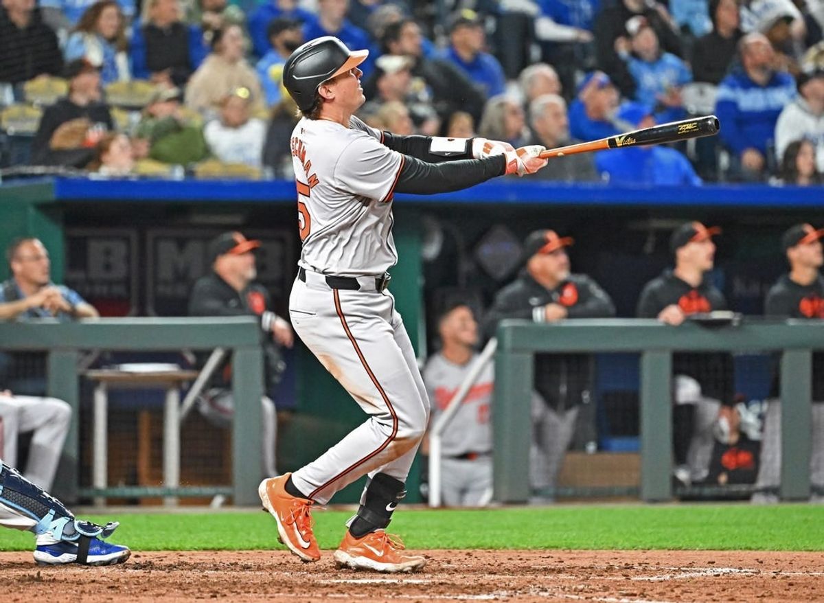 Apr 19, 2024; Kansas City, Missouri, USA; Baltimore Orioles catcher Adley Rutschman (35) hits a grand slam in the seventh inning at against the Kansas City Royals Kauffman Stadium.