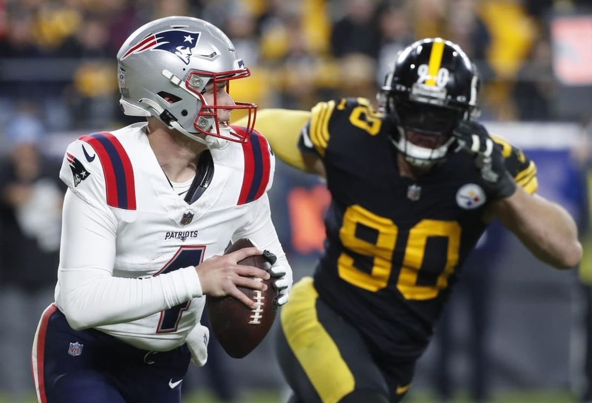 Dec 7, 2023; Pittsburgh, Pennsylvania, USA;  New England Patriots quarterback Bailey Zappe (4) runs the ball as Pittsburgh Steelers linebacker T.J. Watt (90) chases during the third quarter at Acrisure Stadium. New England won 21-18.