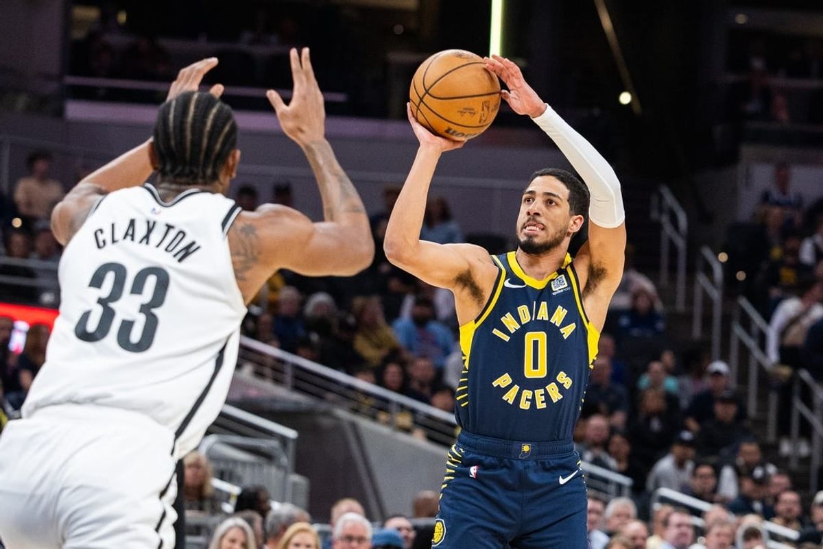 Apr 1, 2024; Indianapolis, Indiana, USA; Indiana Pacers guard Tyrese Haliburton (0) shoots the ball while Brooklyn Nets center Nic Claxton (33) defends in the first half at Gainbridge Fieldhouse.