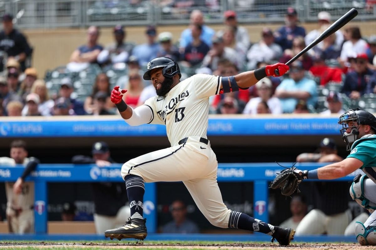 May 9, 2024; Minneapolis, Minnesota, USA; Minnesota Twins Manuel Margot (13) hits a three RBI double against the Seattle Mariners during the first inning at Target Field.