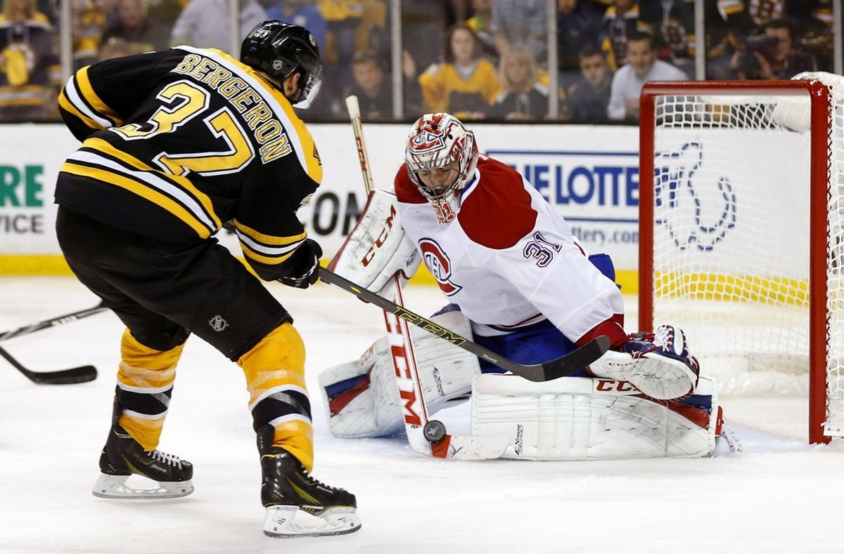 May 14, 2014; Boston, MA, USA; Montreal Canadiens goalie Carey Price (31) makes a save on Boston Bruins center Patrice Bergeron (37)during the second period in game seven of the second round of the 2014 Stanley Cup Playoffs at TD Garden. Mandatory Credit: Winslow Townson-Imagn Images