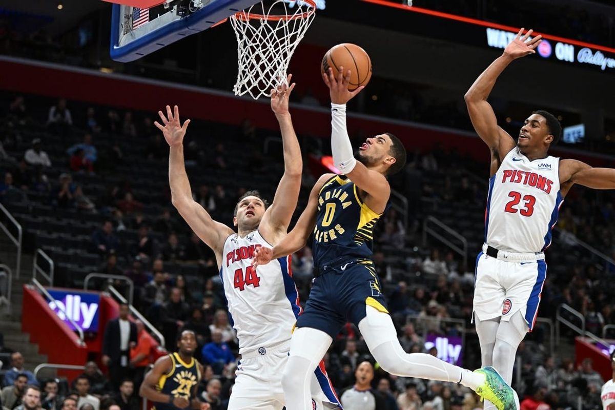 Dec 11, 2023; Detroit, Michigan, USA;  Indiana Pacers guard Tyrese Haliburton (0) drives to the basket against Detroit Pistons forward Bojan Bogdanovic (44) and Pistons guard Jaden Ivey (23) in the second quarter at Little Caesars Arena.