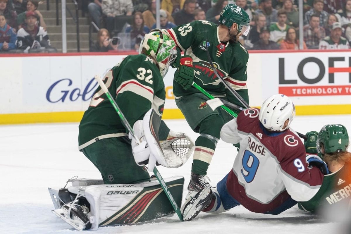 Apr 4, 2024; Saint Paul, Minnesota, USA; Colorado Avalanche left wing Zach Parise (9) is taken down in front of Minnesota Wild goaltender Filip Gustavsson (32) by defenseman Jon Merrill (4) in the first period at Xcel Energy Center.